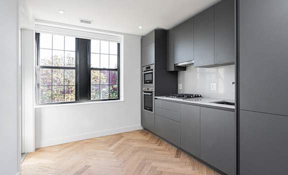 Brand new renovation! Studio apartment kitchen with gas range, dishwasher, built in microwave and oven.