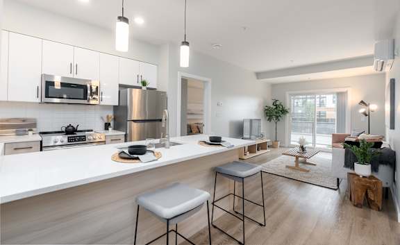 A modern kitchen with a stainless steel refrigerator and a white countertop.