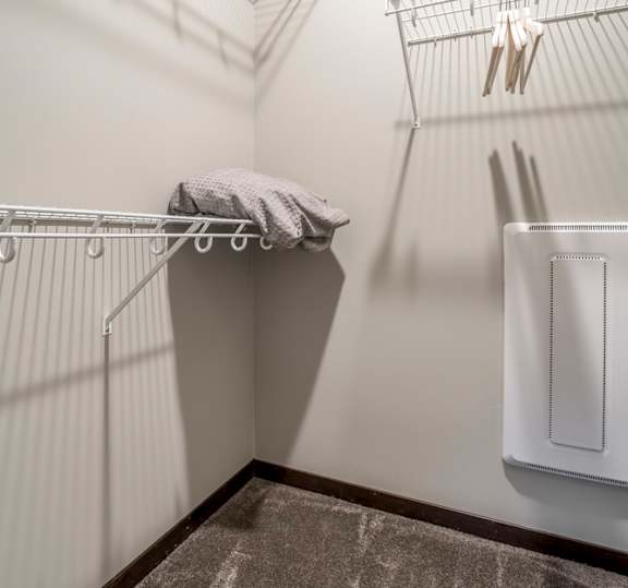 Empty walk in closet with wire shelving for hanging clothes