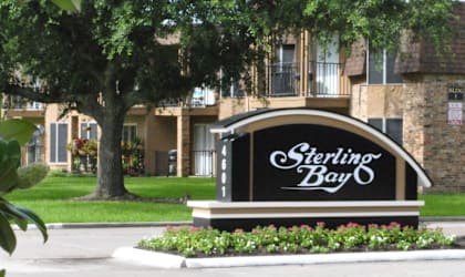 a sign that says sparkling bay in front of a brick building