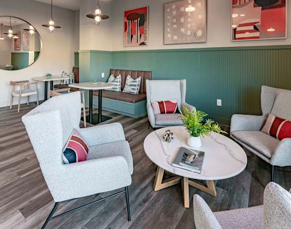 a living room with couches and chairs and a table