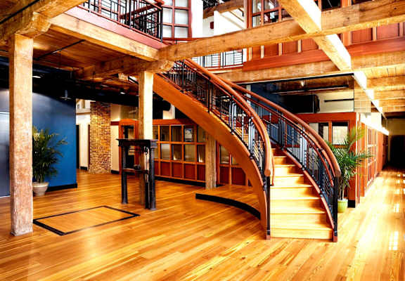 the interior of a building with a staircase and wooden floors