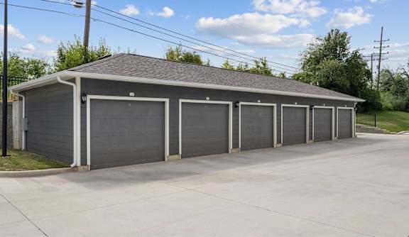 A building with a grey roof and grey garage doors.
