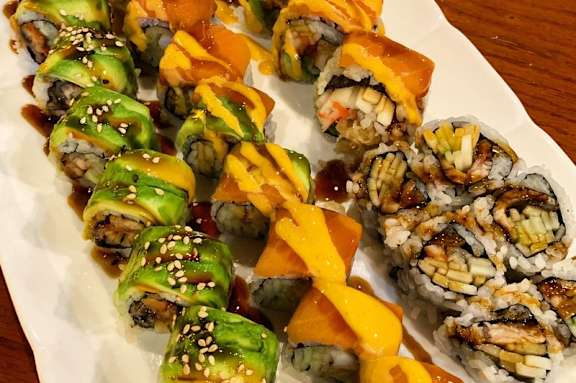 Plate of sushi rolls with different toppings and sauces at The Bosk Apartment Homes, Woodbury, MN