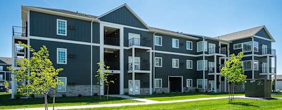 A large building with a parking lot in front of it.