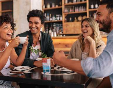 Four people are sitting around a table in a restaurant.