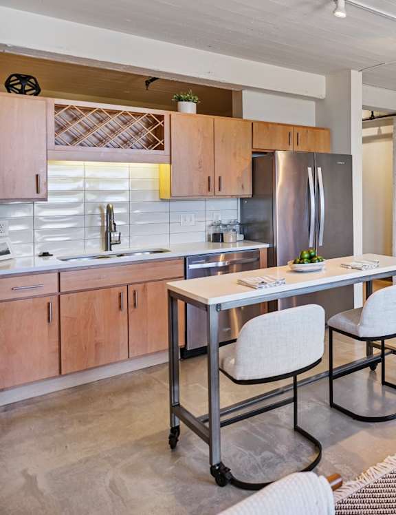 A modern kitchen with a dining table and a couch.