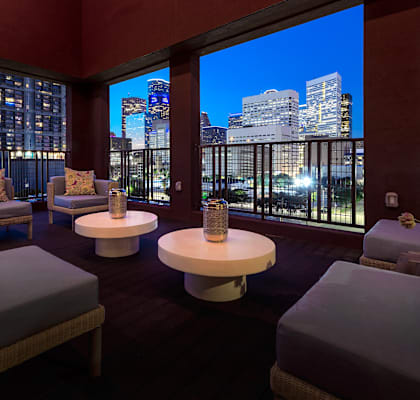 a living room with a view of the city at night