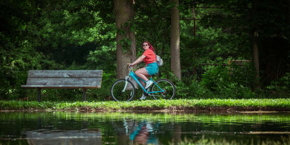 a woman riding a bike near a body of water at Infinity on the Mark, Texas