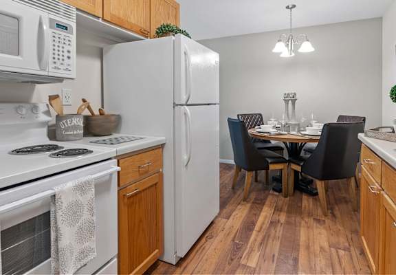 kitchen with wood cabinets and white appliances