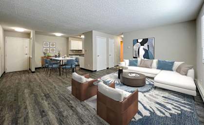 A living room with a grey carpet and a white sofa at The Ridges Apartments, Des Moines, IA