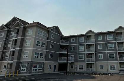 an apartment building with the sun shining over it