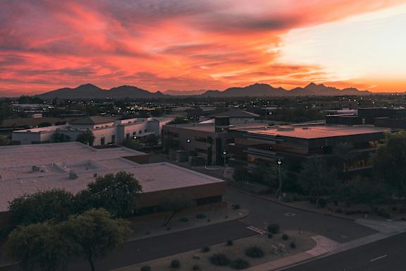 A beautiful sunset paints the sky in vibrant hues over a cityscape.