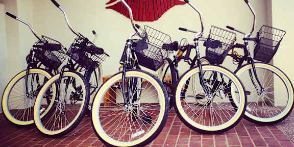 A row of bicycles are parked in front of a wall with a red lipstick print.at Winfield of Scottsdale, Scottsdale, AZ
