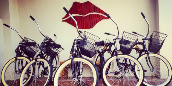 A row of bicycles are parked in front of a wall with a red lipstick print.at Winfield of Scottsdale, Scottsdale, AZ