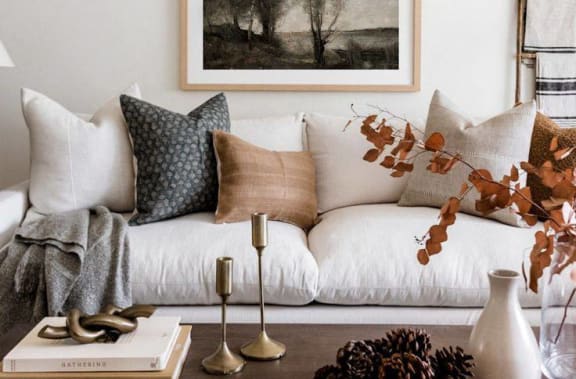 a living room with a white couch and a painting on the wall at 2000 Oasis  Apartments, Atlanta, GA