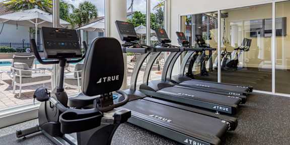 a home gym with weights and cardio equipment