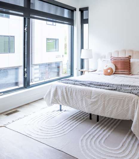 a bedroom with a bed and a large window at Matilda 235 Townhomes, Des Moines, 50309