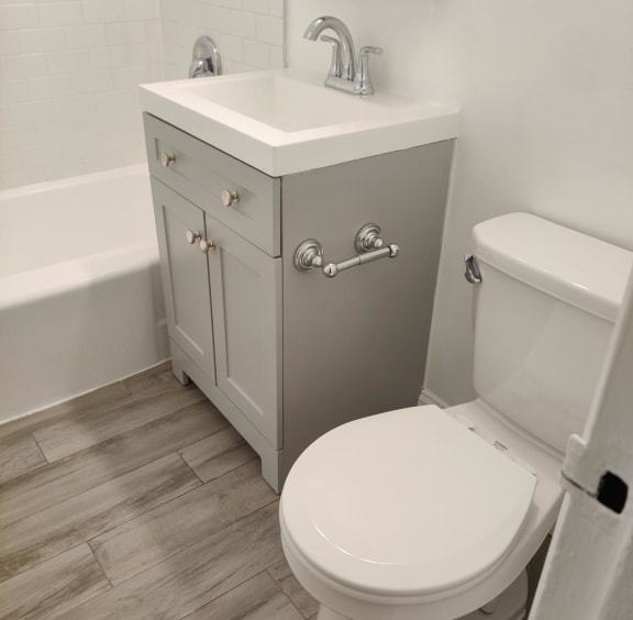 a small bathroom with a sink toilet and bathtub