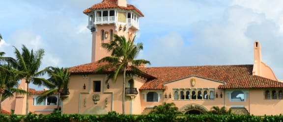a large pink building with a clock tower at Piper Village West, Florida