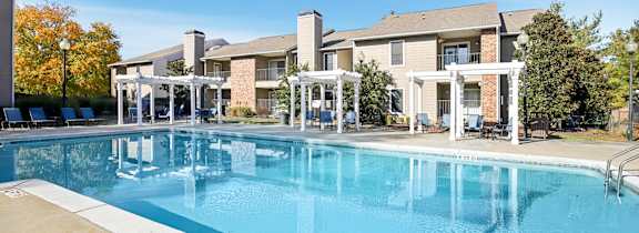 A large house with a pool in front.