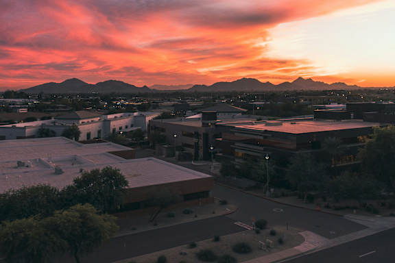 A beautiful sunset paints the sky in vibrant hues over a cityscape.