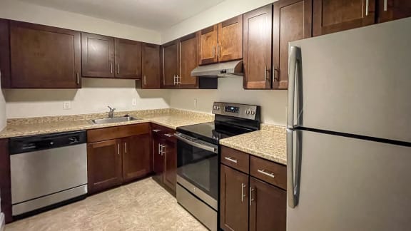 a kitchen with stainless steel appliances and wooden cabinets