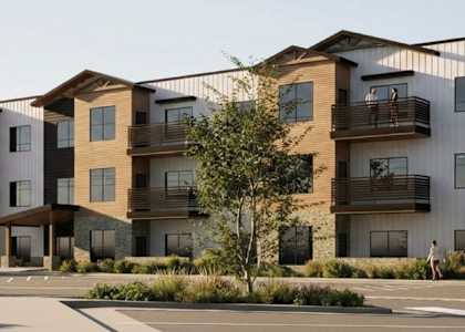 A modern apartment complex with multiple balconies and a courtyard.