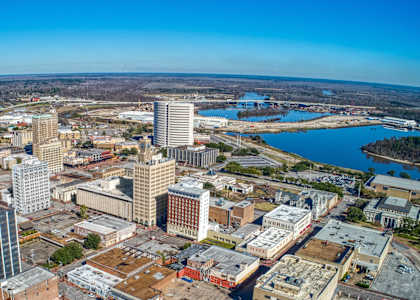 an aerial view of a city with tall buildings and a river