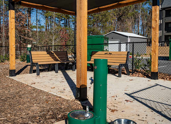 a water fountain in a park with benches