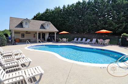 the pool is in front of the pool house