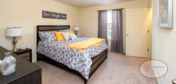 a bedroom with a large bed and a window