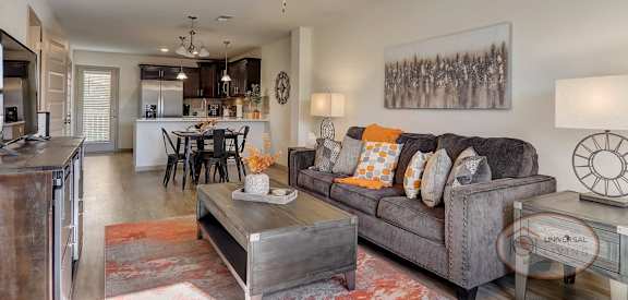 a living room with a couch and a ceiling fan
