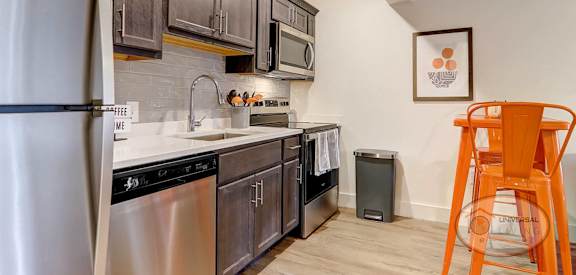 kitchen with stainless steel appliances and wooden cabinets in a home