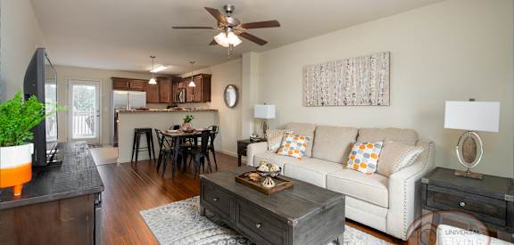 a living room and kitchen with a couch and a table