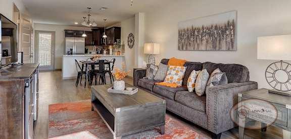 a living room with a couch and a ceiling fan