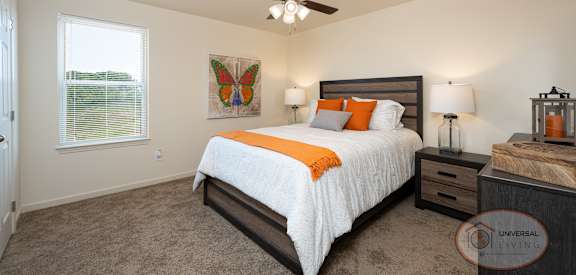 a bedroom with a bed and a ceiling fan