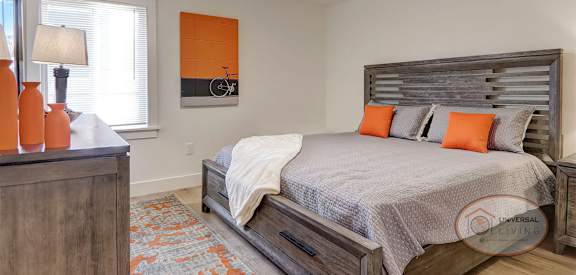 a bedroom with a bed and a ceiling fan