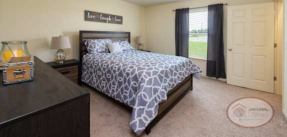 a bedroom with a bed and a dresser and a window