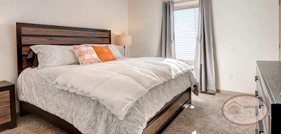 a bedroom with a bed and a ceiling fan