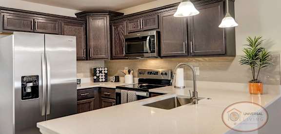 a kitchen with stainless steel appliances and a white counter top