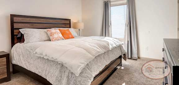 a bedroom with a bed and a ceiling fan