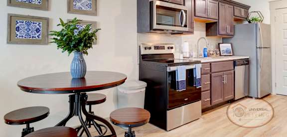 a kitchen with stainless steel appliances and a small table