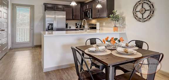 an open kitchen and dining room with a table and chairs