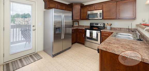 a kitchen with stainless steel appliances and wooden cabinets