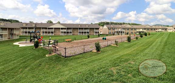 an image of a playground in front of an apartment building