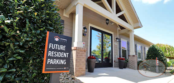 a future resident parking sign in front of a building
