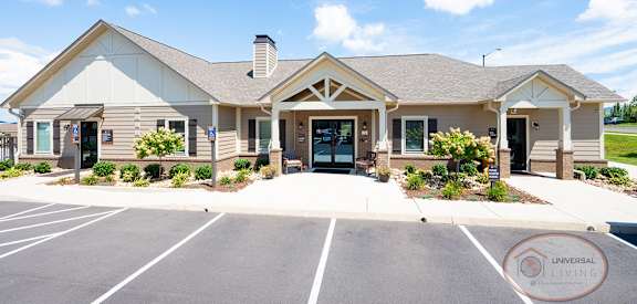 the exterior of a building with a parking lot and a driveway