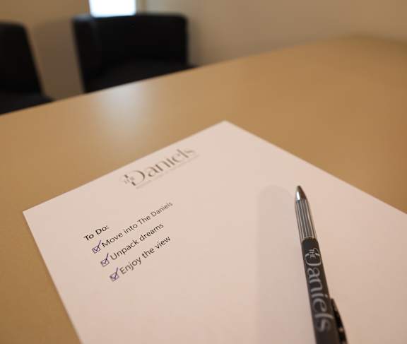 A to do list with a pen on a table.