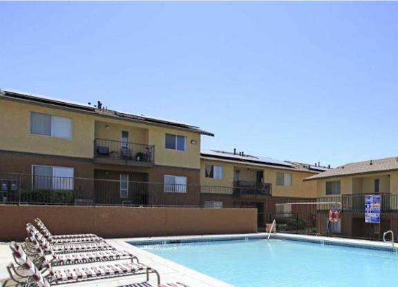 A swimming pool in front of apartment buildings.